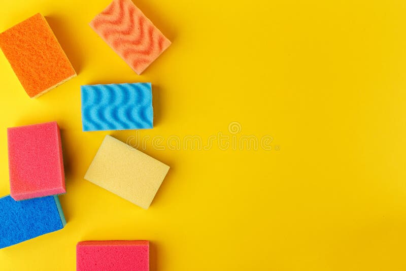 Set multi-colored sponges on a yellow background, space for text. Multi colored foam sponges stock images, royalty-free photos and pictures