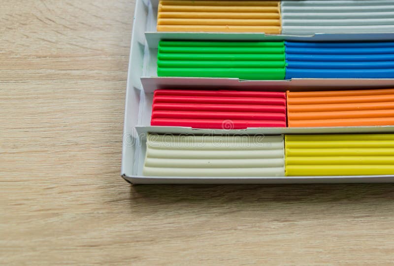 Set of multicolored plasticine bars for modeling on wooden table. Top view, eduction and creativity concept. royalty free stock photography Set of multicolored plasticine bars for modeling on wooden table. Top view, eduction and creativity concept. royalty free stock photography