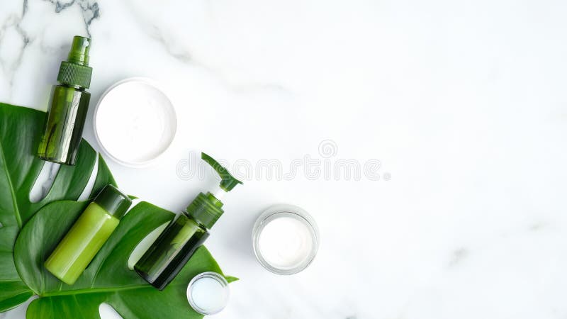 Set of natural organic cosmetics for skincare, body and hair care with tropical leaf on marble background. SPA and beauty