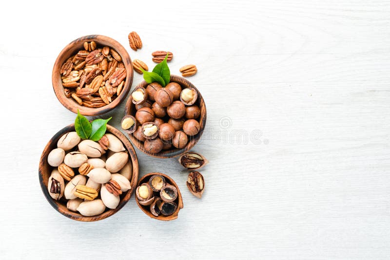 Set of Nuts. Pecans and Macadamia Nuts in Bowls on a White Background