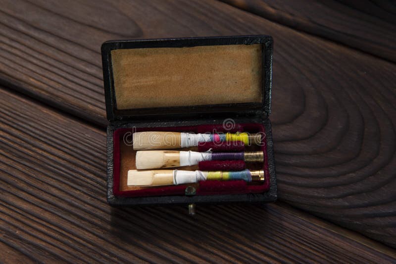 Set of oboe reeds on a wooden surface royalty free stock photography