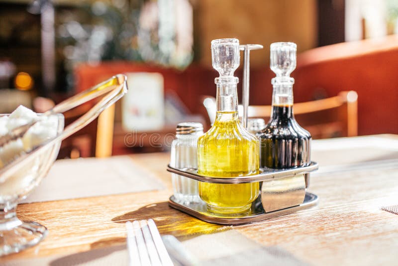 A Set of Olive Oil with Soy Sauce and Sugar Bowl on a Table in the Cafe