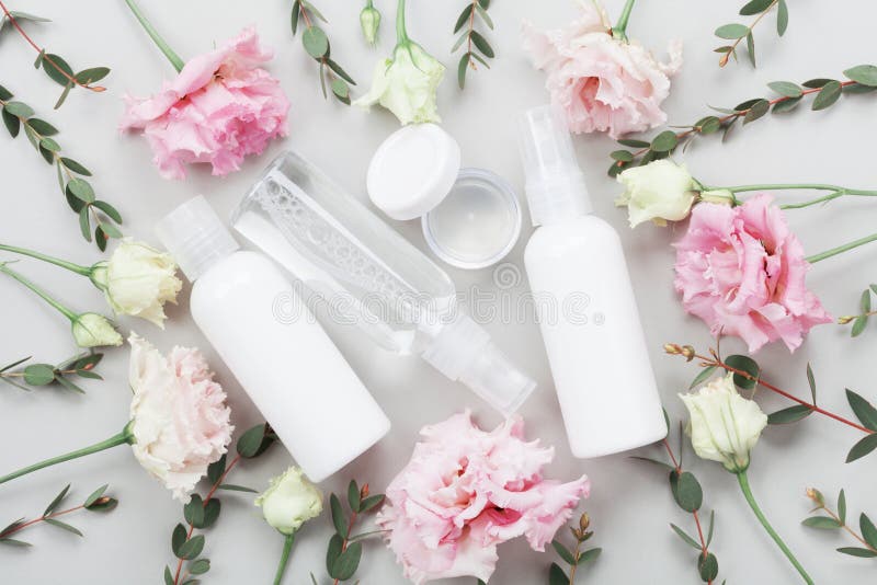 Set of organic natural cosmetic decorated with pastel flowers and green eucalyptus leaves on table top view. Flat lay. royalty free stock images Set of organic natural cosmetic decorated with pastel flowers and green eucalyptus leaves on table top view. Flat lay. royalty free stock images