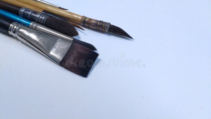 Paint Brushes With Gouache In Cup Isolated On White Stock Photo