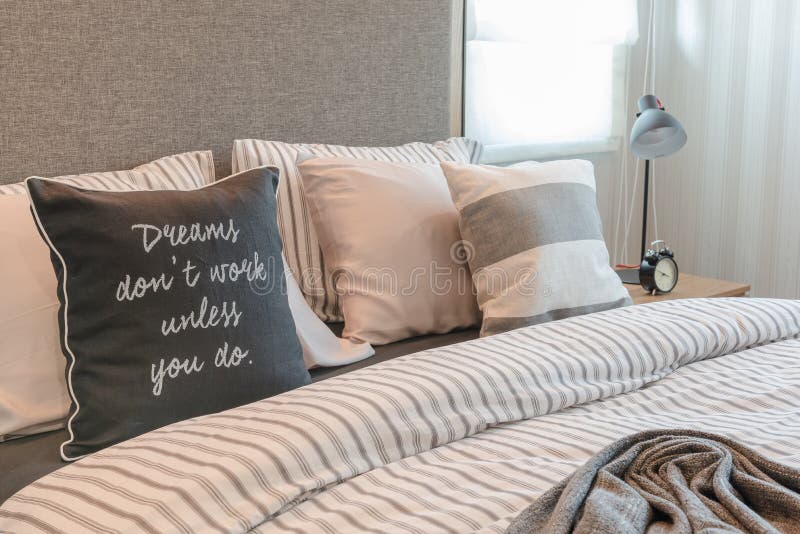 Set of Pillows and Blanket on Bed in Modern Bedroom Interior Stock