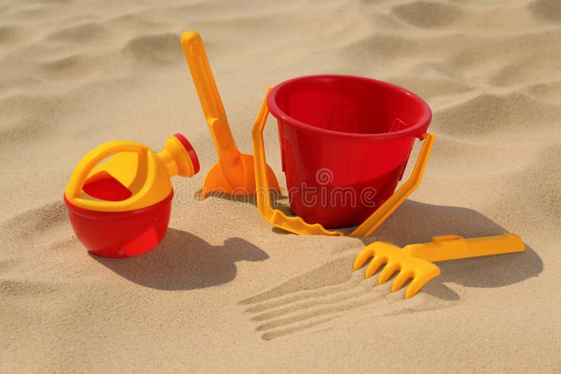 Set of Plastic Beach Toys and Flip Flops on Sand, Flat Lay. Outdoor