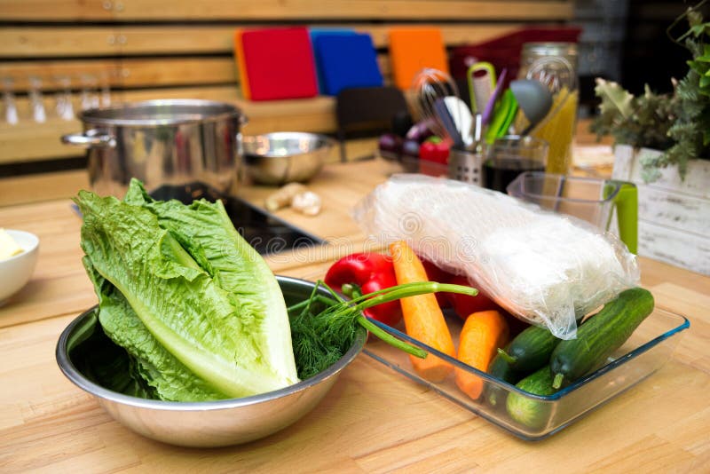 Set of raw foods on the table bowl of lettuce leaves, dill, cucumbers, peeled carrots, glass noodles royalty free stock image Set of raw foods on the table bowl of lettuce leaves, dill, cucumbers, peeled carrots, glass noodles royalty free stock image