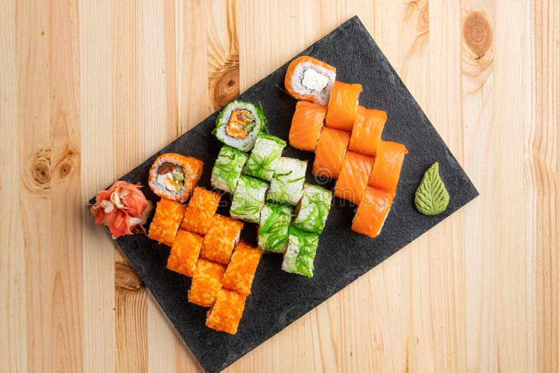 Set of Rolls with Wasabi and Pickled Ginger on Stone Serving Board