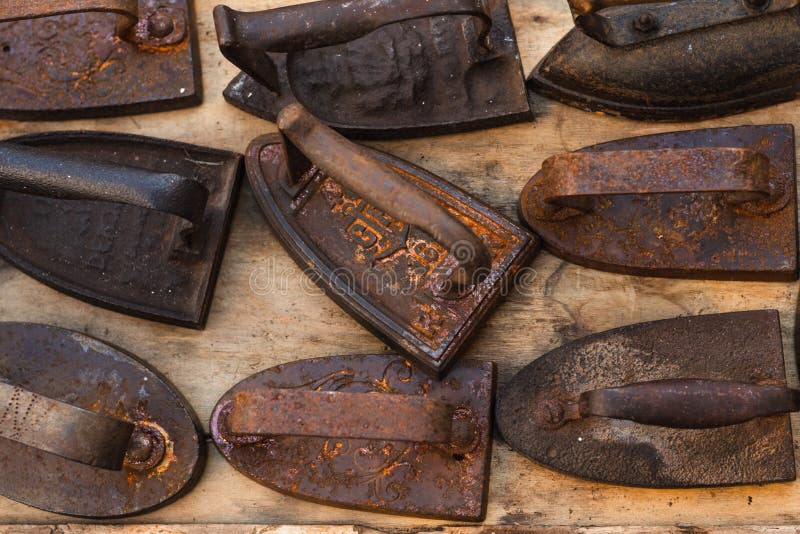 Set of Rusty Cast Iron and Steel Irons on a Flea Market Stock Image