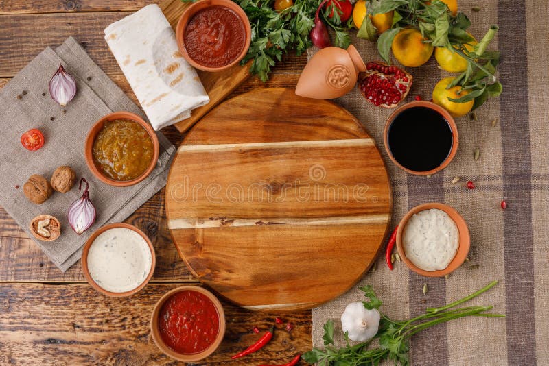A set of sauces and seasonings in ceramic cups and ingredients for them top view. royalty free stock photo A set of sauces and seasonings in ceramic cups and ingredients for them top view. royalty free stock photo