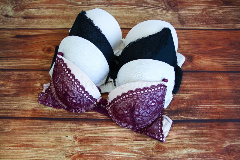 Set of Bras on Wooden Background Stock Image - Image of lingerie