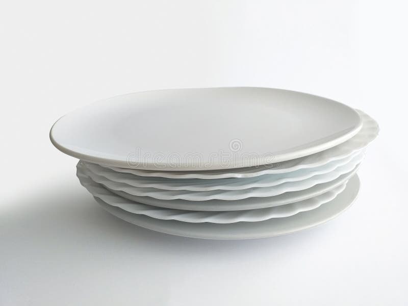 Set of Stacked Ceramic Plain Plates Isolated on White Background. Empty