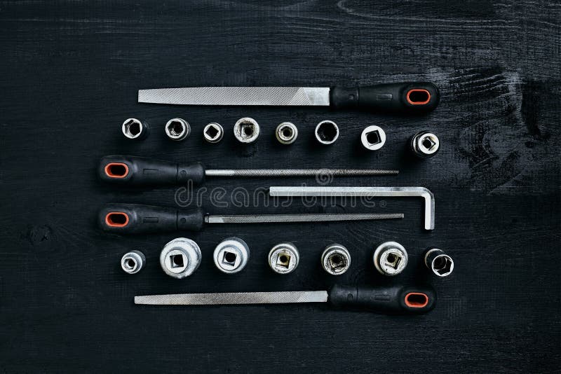 Set of tools chisel, wrenches on black wooden background. Close up. Top view. Space for your text or product display. Still life. Flat lay