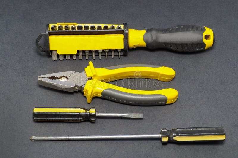 A set of tools on a gray background pliers, screwdriver. royalty free stock images A set of tools on a gray background pliers, screwdriver. royalty free stock images