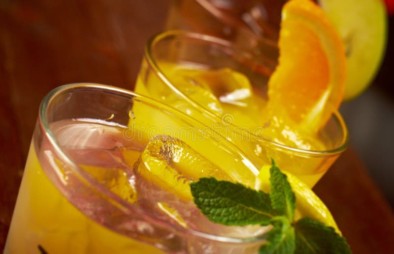 Cold Cocktail with Lemon and Champagne in Tall Glass on Backdrop of the Restaurant Atmosphere