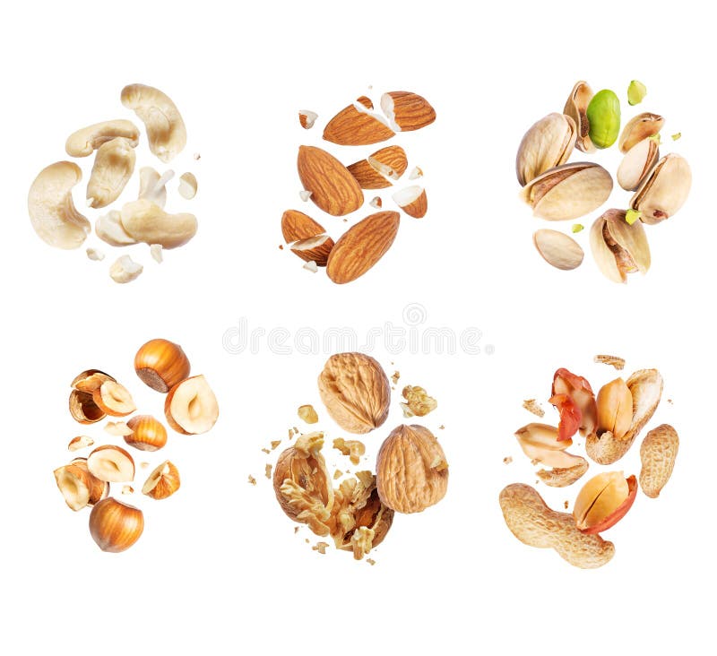 Set of various crushed dried nuts close-up in the air isolated on a white background stock photos