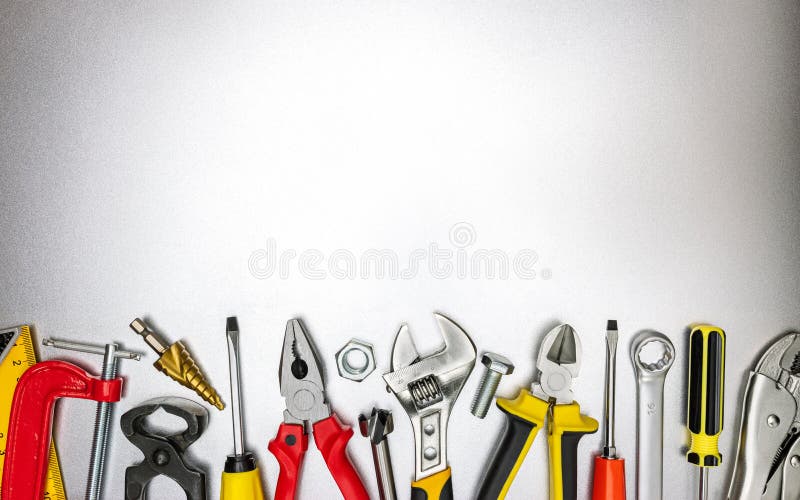 Set of various hand work tools for construction and renovation job on metal desk. top view