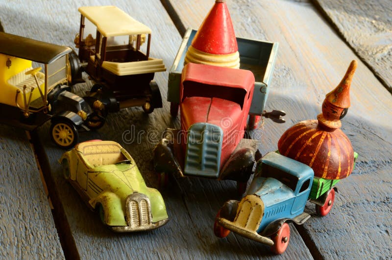 Set of vintage toys - convertible toy car, trucks (lorries) toy, post car toy and spinning (humming) tops