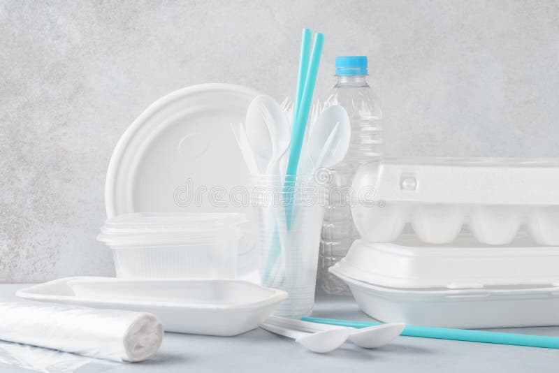 Set of white plastic disposable tableware and packaging