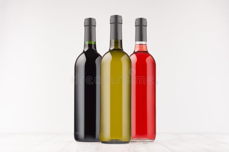 Set wine bottles different colors - red, green, black- on white wooden board, mock up. stock image Set wine bottles different colors - red, green, black- on white wooden board, mock up. stock image