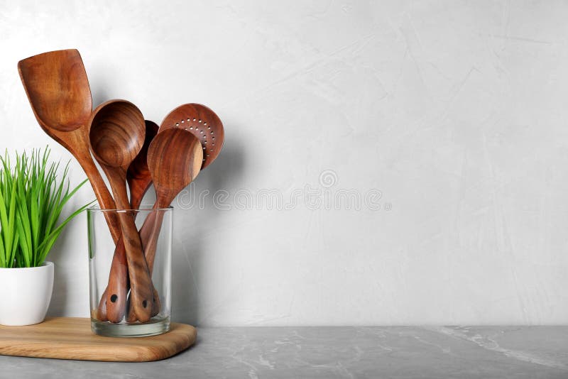 https://thumbs.dreamstime.com/b/set-wooden-kitchen-utensils-glass-holder-houseplant-light-grey-marble-table-space-text-235550953.jpg