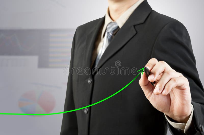 Businessman hand drawing chart with green arrow. Businessman hand drawing chart with green arrow