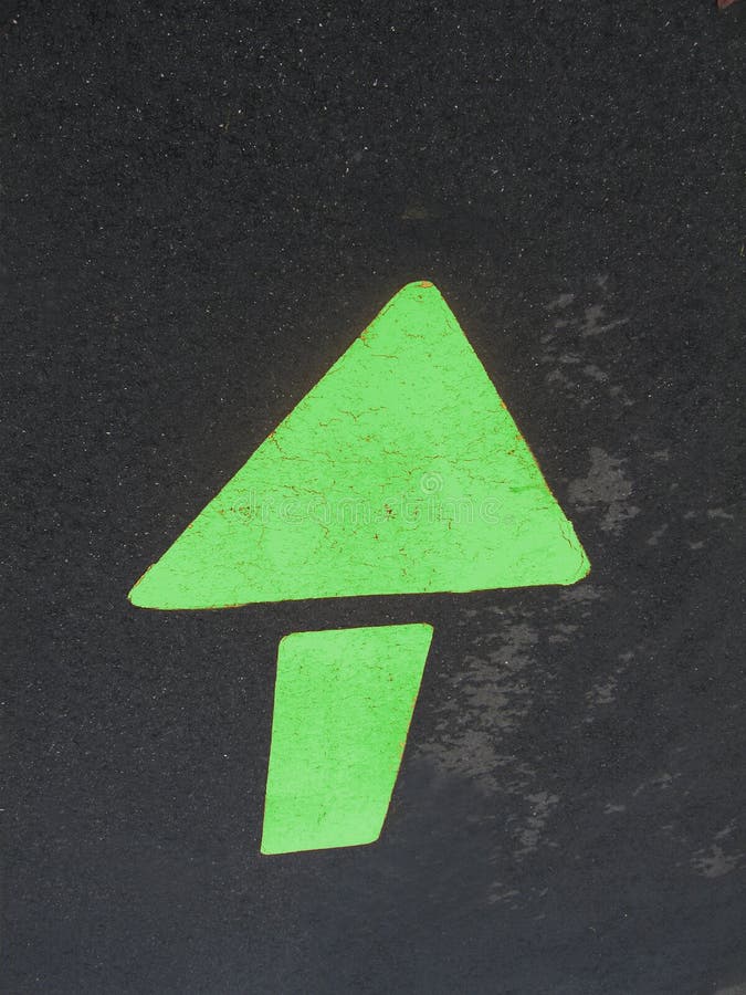 Green arrow on asphalt road. Green arrow on asphalt road