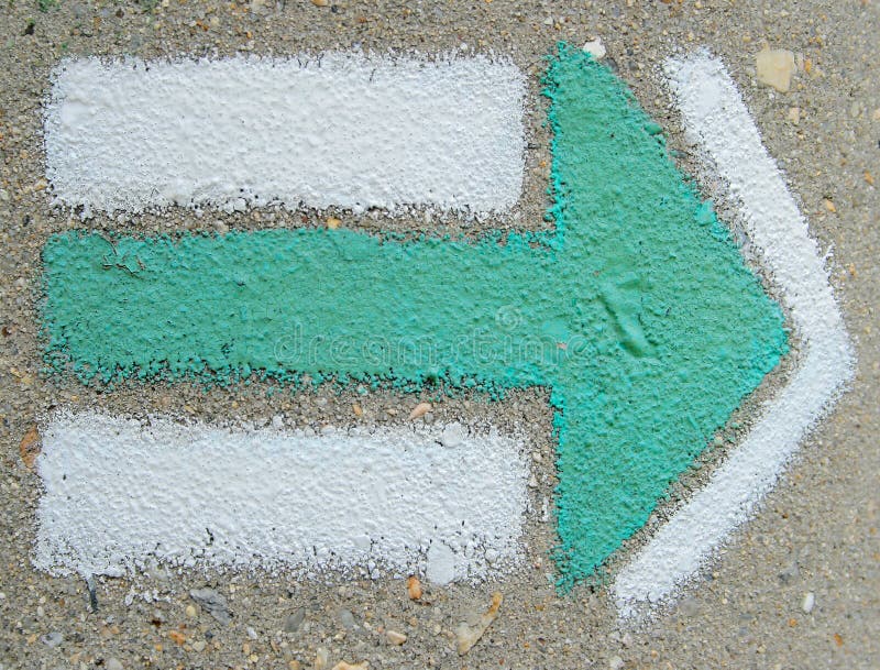 Green direction arrow at wall. Green direction arrow at wall