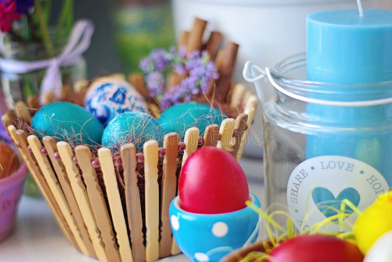 Seth Easter Eggs in a Wooden Basket and Candlestick with Candle Stock