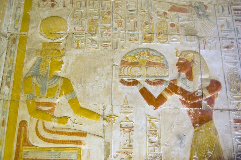 Seti offering food to the goddess Hathor. The Ancient egyptian Pharaoah Seti offering a tray of food to the goddess Hathor, wearing her crown of cow horns. The royalty free stock photos Seti offering food to the goddess Hathor. The Ancient egyptian Pharaoah Seti offering a tray of food to the goddess Hathor, wearing her crown of cow horns. The royalty free stock photos