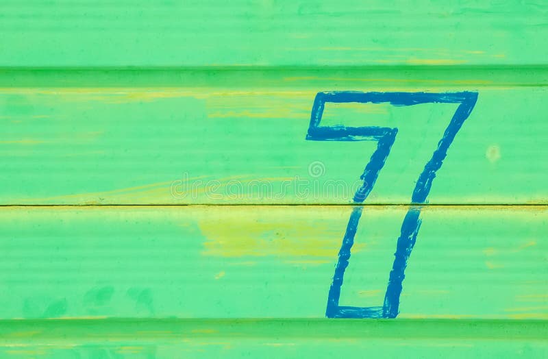 Number seven painted on a battered metal door. Number seven painted on a battered metal door
