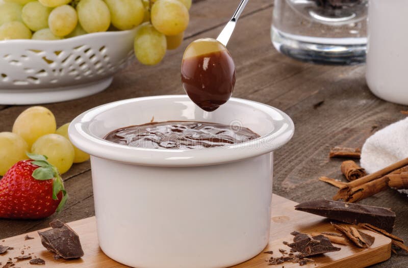 Setting of Chocolate fondue with grapes