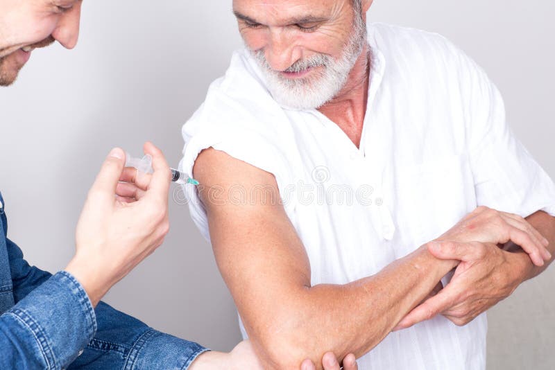 Setting an Injection on the Arm of an Elderly Man Stock Photo Image