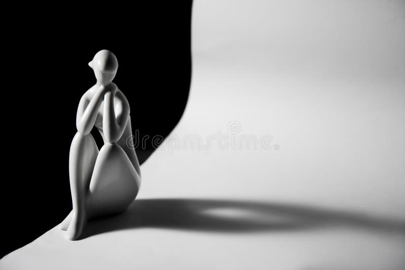 A simple smooth ceramic statue on black and white background - symbolizing loneliness, lone time, contemplation, thinking, melancholy, sadness, memories. A simple smooth ceramic statue on black and white background - symbolizing loneliness, lone time, contemplation, thinking, melancholy, sadness, memories.