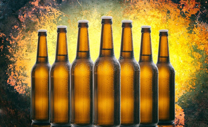 Seven glass beer bottles isolated on old yellow black background. 
