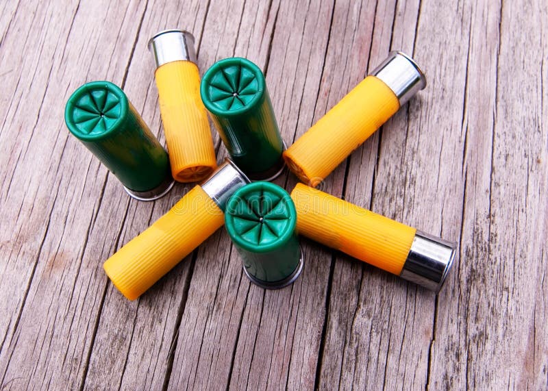 Seven shotgun shells, three green and four yellow. 