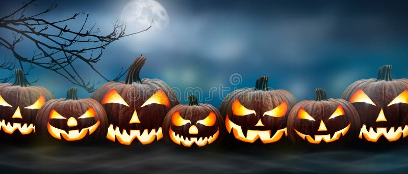Seven spooky halloween pumpkin, Jack O Lantern, with an evil face and eyes on the grass with a misty night sky background with a
