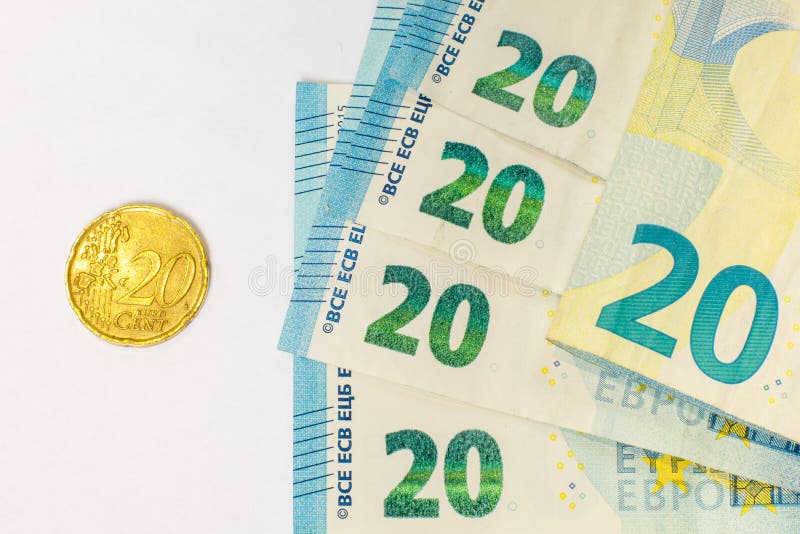 Several banknotes of 20 euros and a coin of 20 cents. The concept of opposing large and small earnings, saving or spending money royalty free stock photography Several banknotes of 20 euros and a coin of 20 cents. The concept of opposing large and small earnings, saving or spending money royalty free stock photography