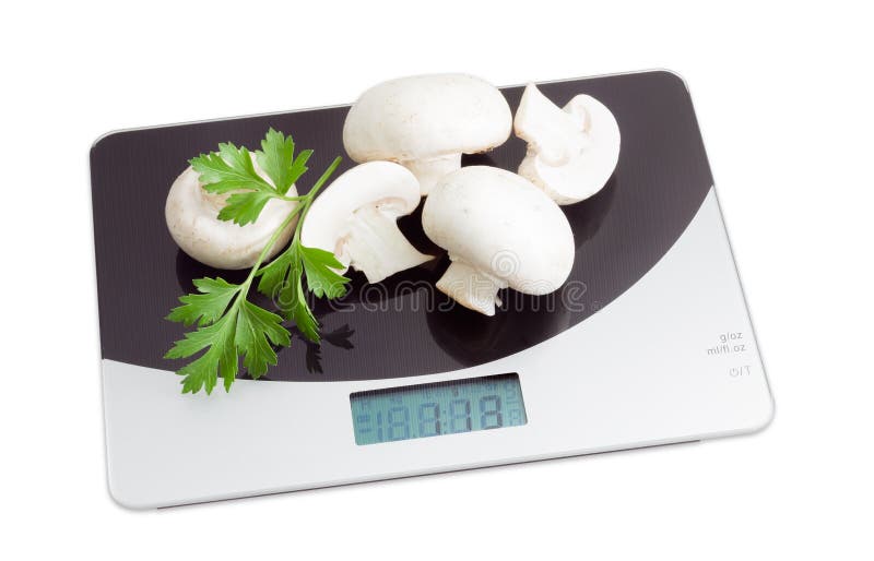 Several champignon mushroom on digital kitchen scale