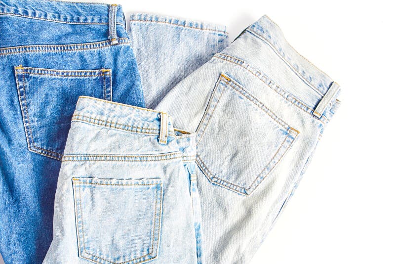 Several folded pairs of jeans in various shades of blue and light blue stock image Several folded pairs of jeans in various shades of blue and light blue stock image