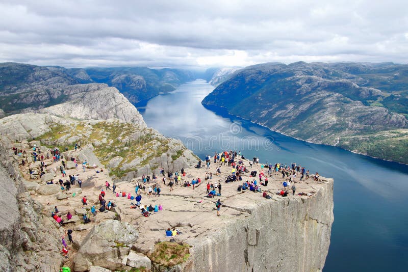 Several hikers enjoying the views in the summit of the Pulpit Rock Preikestolen, Norway.