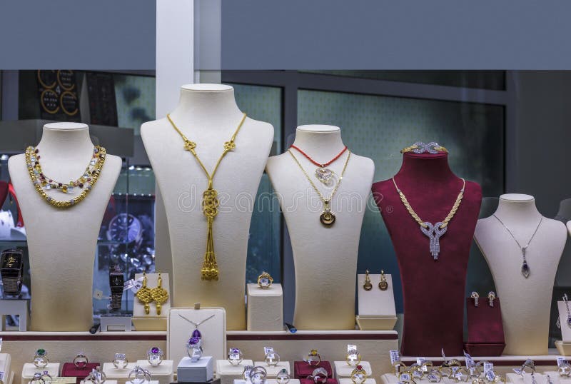 Several necklaces on jewellery showcase in window