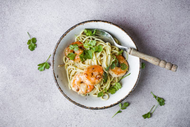 Several Portions of Cooked and Twisted Spaghetti Pasta with King Prawn