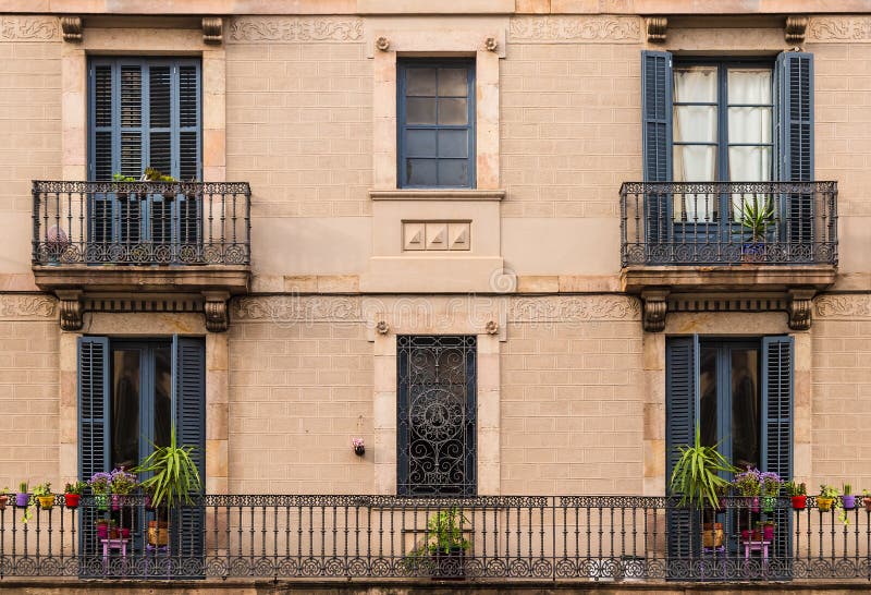 Windows and balconies in row on facade of historic building stock images