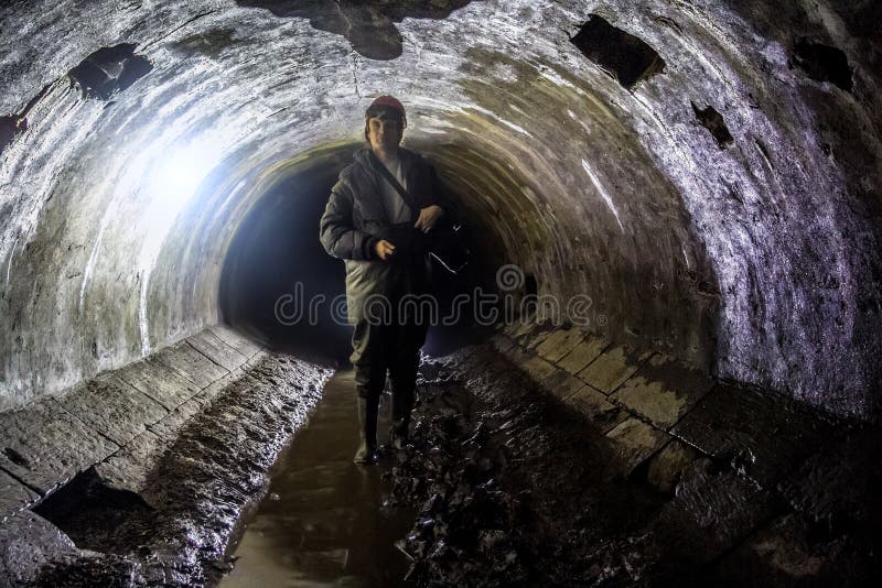 Sewer worker in underground sewer tunnel stock photos