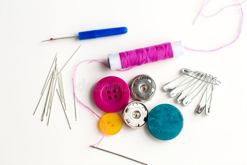 Sewing buttons, needles, pins and thread spool royalty free stock photography
