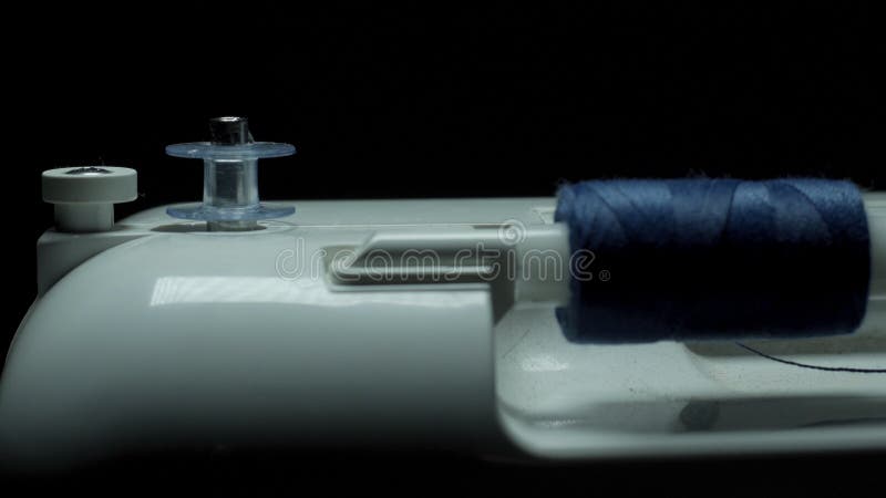 Sewing Machine on a Black Background, Appears from the Darkness Stock