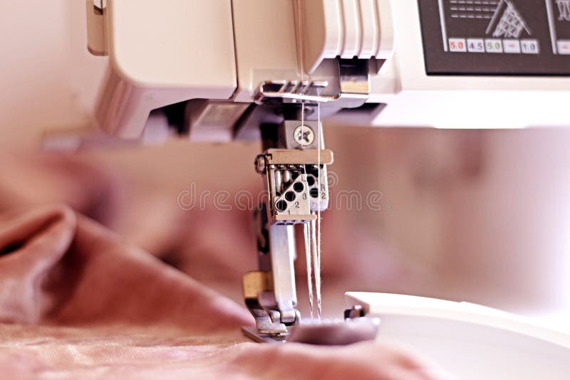 Sewing Machine Coverlock Processes the Edges of the Fabric Stock Photo