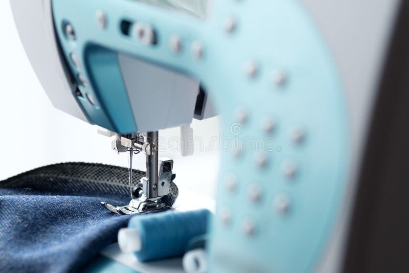 Sewing Machine with Denim and Thread for Sewing, Closeup. Part of a