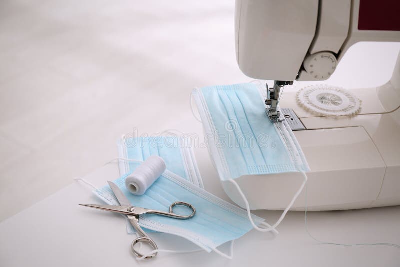 Sewing Machine with Face Mask on Table, Space for Text Stock Photo
